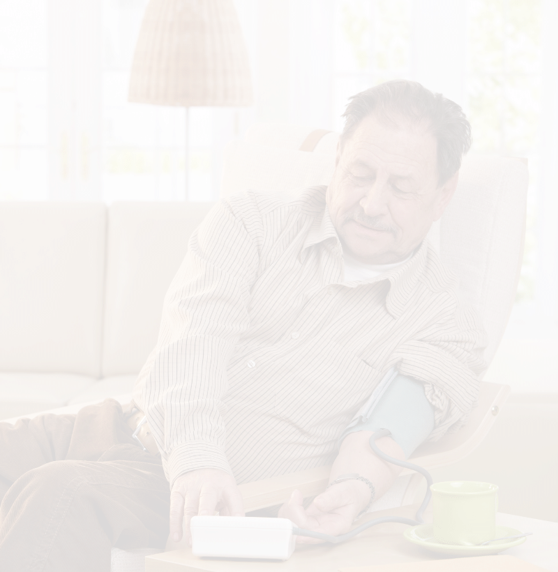 Man on couch taking blood pressure reading
